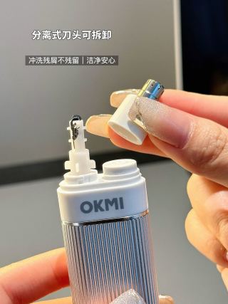 Black and white OKMI trimmers side by side - both color options, pen-style body, compact size
