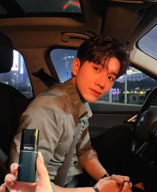 Man in car holding OKMI trimmer - men's grooming essential, clean appearance, professional image