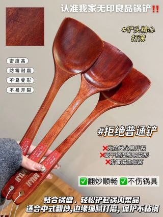 Three spatulas on wooden surface showing full length - extended handle for safe distance from heat