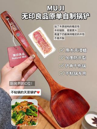 Three solid wood spatulas held in hand showing consistent grain, size, and curved spatula head