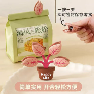 Hand removing individual leaf clip from green pot - easy one-handed clip removal, always within reach