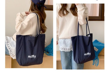 Red stripe Miffy tote on model - showing full bag size, handle length, and 3D Miffy plush detail