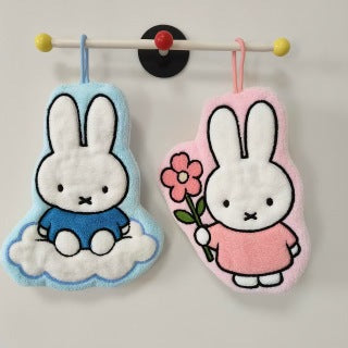 Bow Miffy and Pink Flower Miffy hanging on wall rack - pink dress and golden bow detail